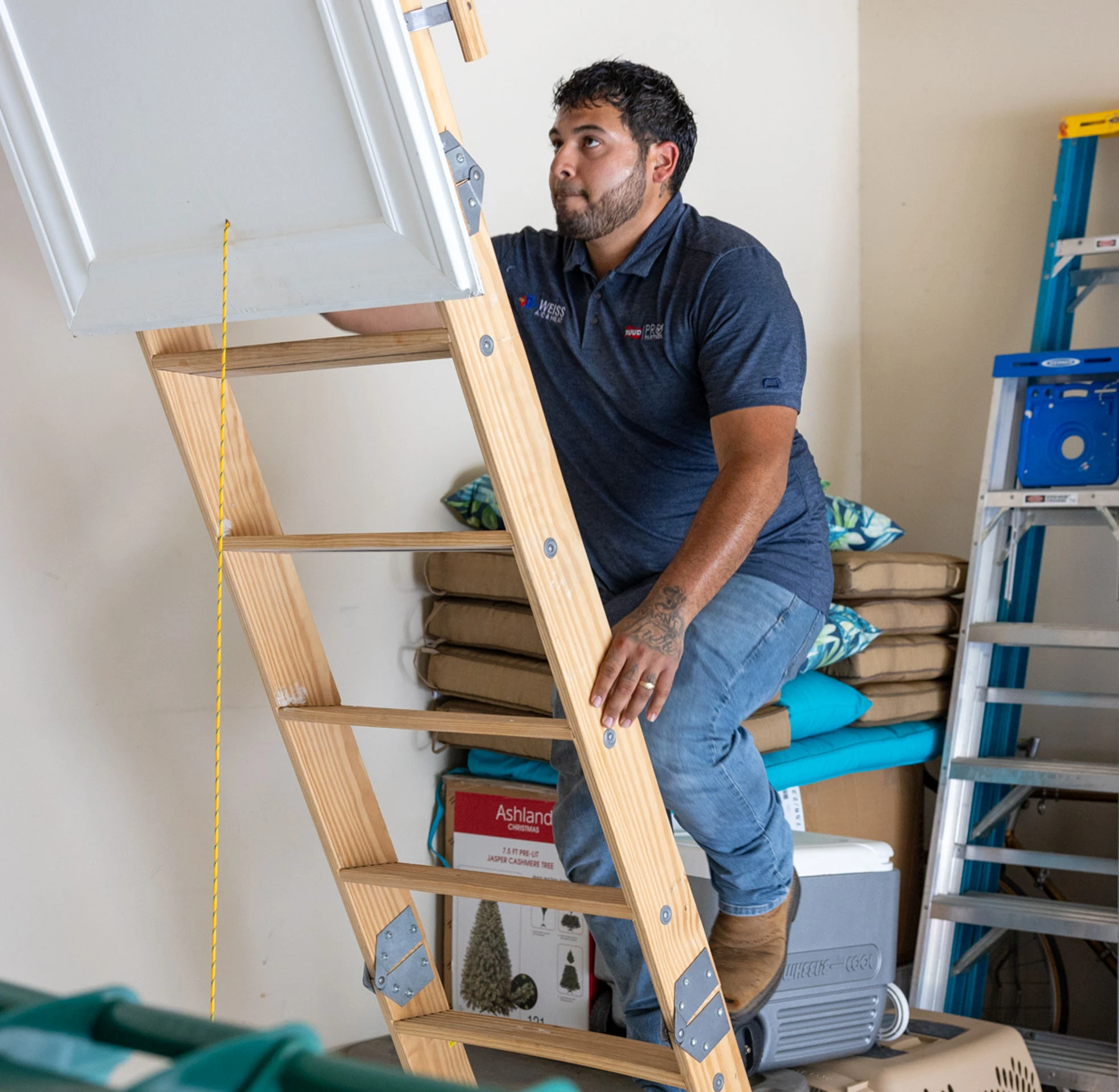 tech on attic ladder