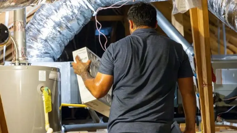 a professional Weiss Air Conditioning and Plumbing technician changing out a filter during routine HVAC maintenance