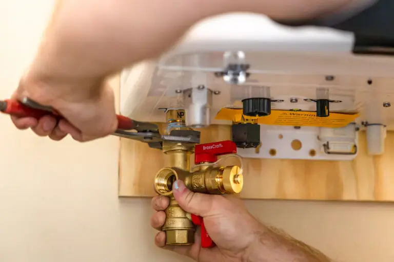Professional plumber installing a tankless water heater in a Montgomery County home.