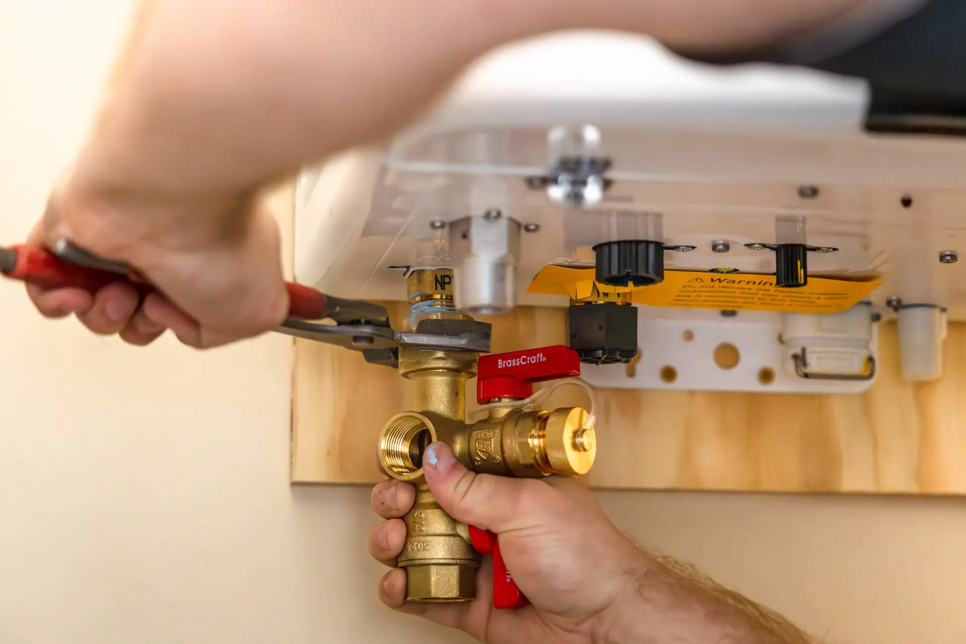 Professional plumber installing a tankless water heater in a Montgomery County home.