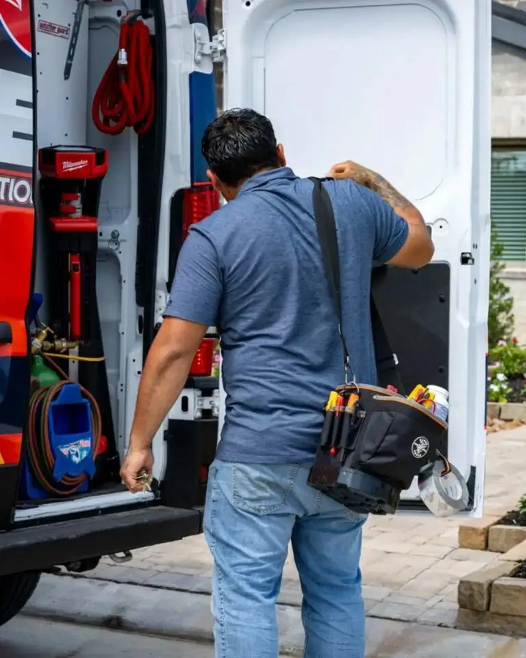 Weiss AC and Plumbing tech getting his gear out of the van to get ready for a job.
