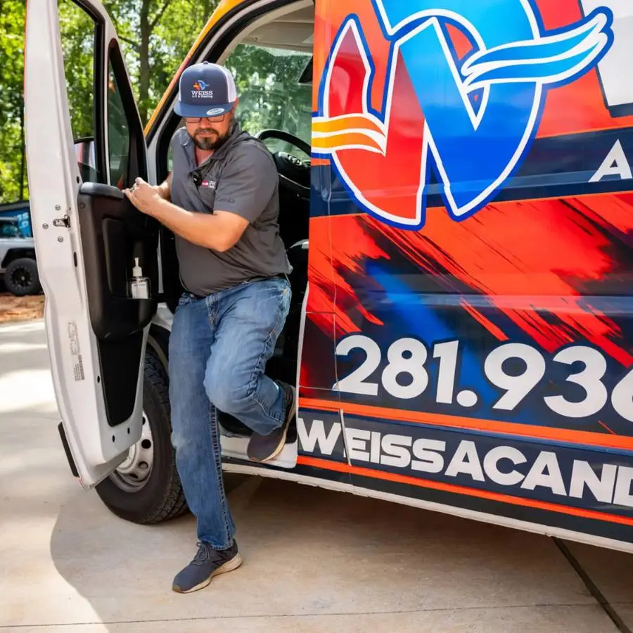 Weiss AC tech getting out of van at residential job
