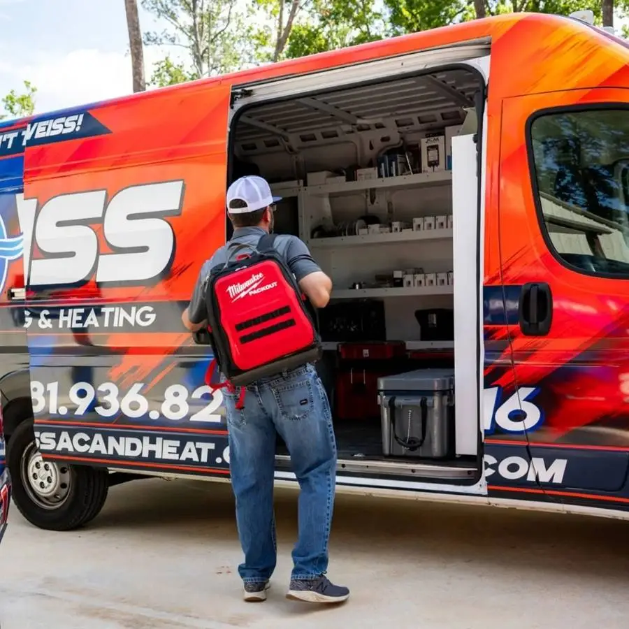 A Weiss Air Conditioning & Plumbing technician with a red Milwaukee tool backpack stands next to a fully stocked service van ready for an AC repair call in Conroe.