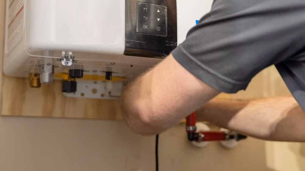 Weiss AC & Plumbing Navien Service Specialist is installing a Navien tankless water heater.