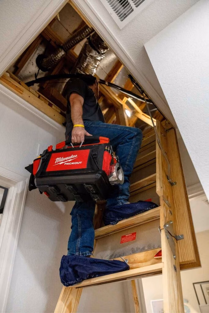 Professional HVAC technician performing a comprehensive maintenance inspection on a central air conditioning unit for a home in the Bentwater community of Montgomery TX.