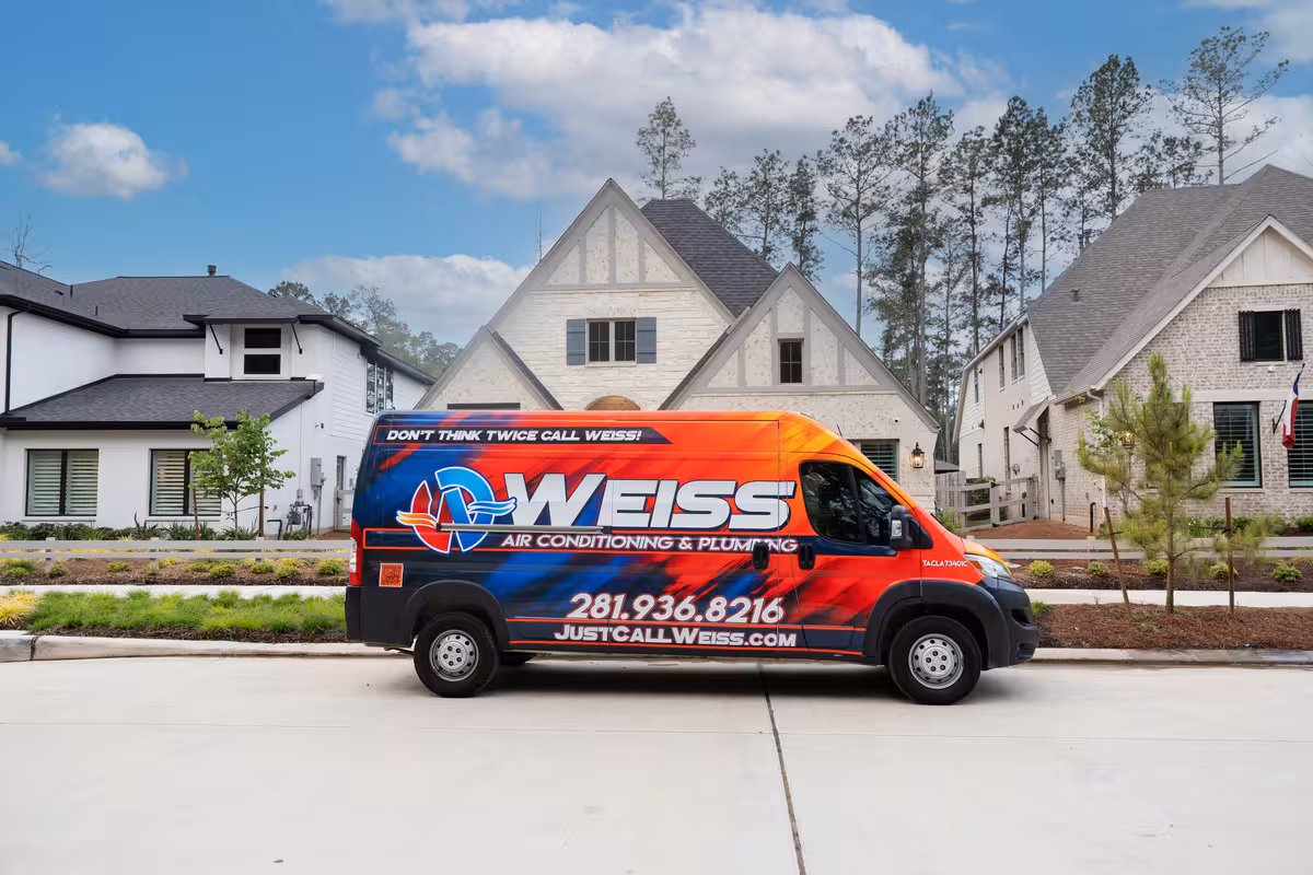 Weiss Air Conditioning & Plumbing company vehicle parked outside a residence in Montgomery County, Texas.