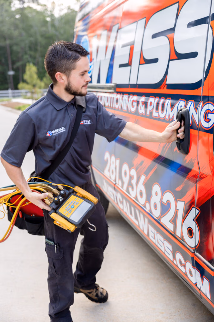 Weiss Air Conditioning & Plumbing HVAC technician closing vehicle door.