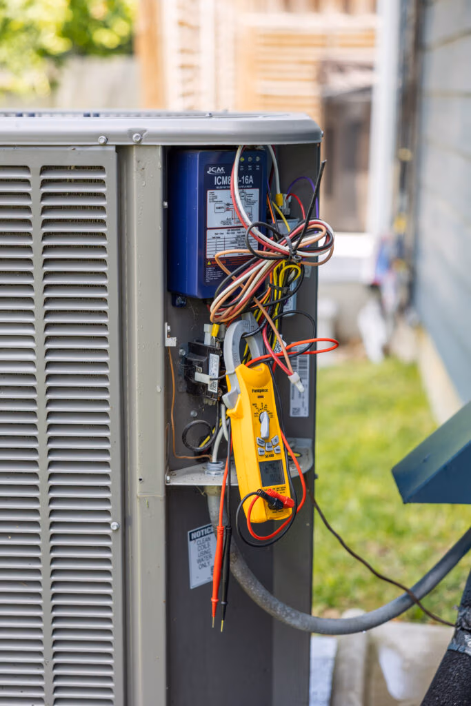 Weiss Air Conditioning & Plumbing tech fixing an outdoor unit in Woodforest.